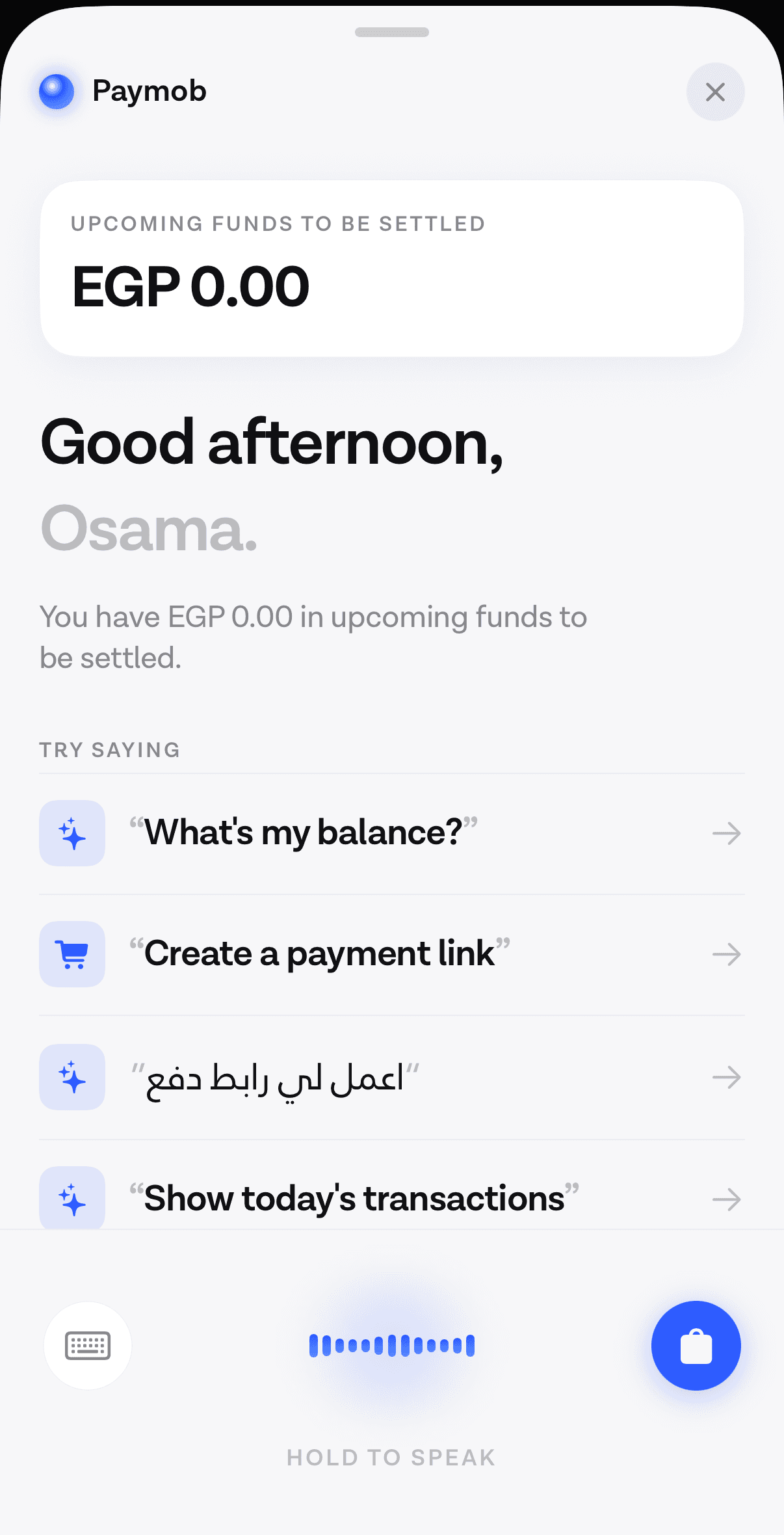 The opening screen of the Voqal assistant inside a payments app, showing an upcoming-funds figure, a greeting, and a short list of example things to say in English and Arabic.